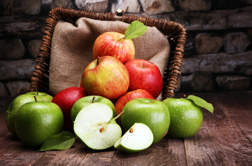 Ripe red apples and green apple on wooden background