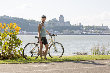 Young Woman Riding Bike outside with quebec view