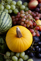 Autumn harvest concept. Seasonal fruits and vegetables on a stone tabletop, top view
