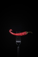 Red hot chili pepper on fork