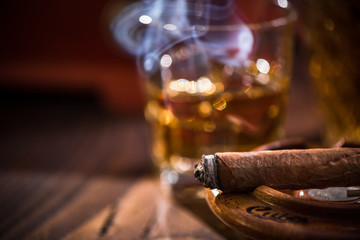 Smoking cigar in vintage ashtray