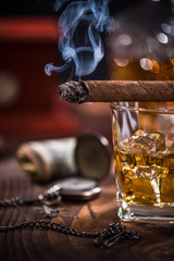 Smoke from Cuban Cigar and luxurious items in background