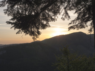 A trail from an airplane in the dawn sky. Dawn in the mountains