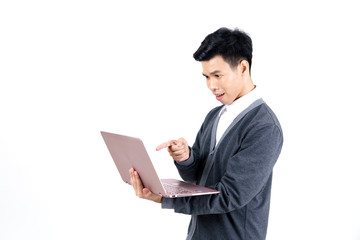 Fototapeta na wymiar Young Asian male student in grey jacket pointing his finger at laptop isolated on white background
