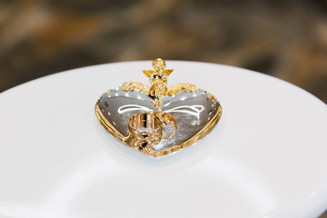 Gold wedding rings on the stand for rings