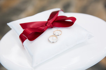 Gold wedding rings on the pillow