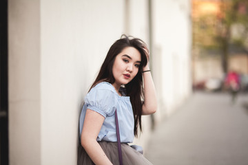 Young Asians girl with modern dress posing in an old Krakow