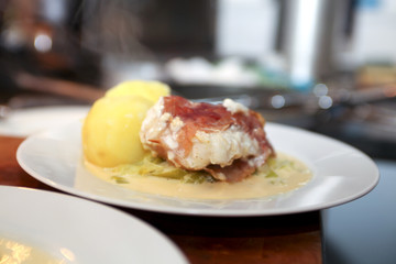 Catfish with bacon on a plate