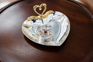 Gold wedding rings on the stand for rings