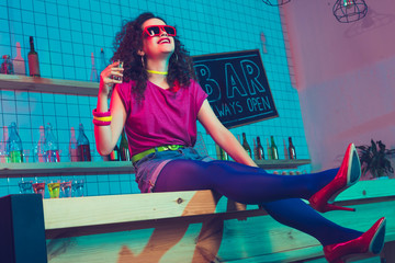 smiling woman with shot in bar
