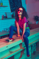 stylish woman sitting on counter