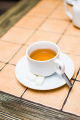 Fototapeta na wymiar Cup of tea on vintage wooden background