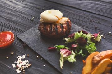Grilled beef steak on dark wooden table background