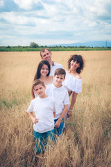 happy family in the field of wheat