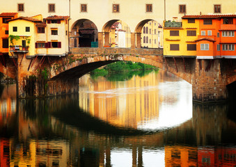 famous bridge Ponte Vecchio with reflection, Florence, Italy, retro toned