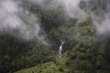 Stream waterfalls from Kaunertaler Glacier lake on mountain in Kaunergrat nature park