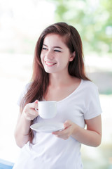 young woman enjoy drinking coffee outdoor on balcony