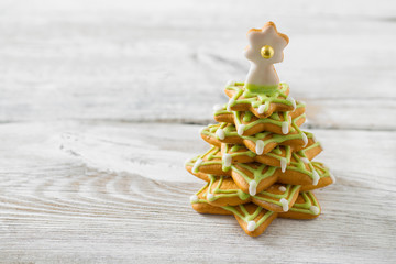Gingerbread tree on white wooden surface