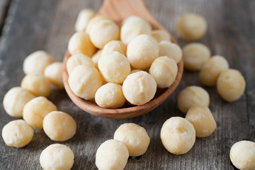 salted macadamia nuts on wooden surface