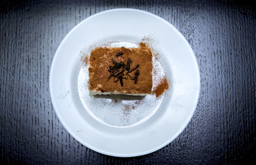 piece of cake on a plate on a dark background