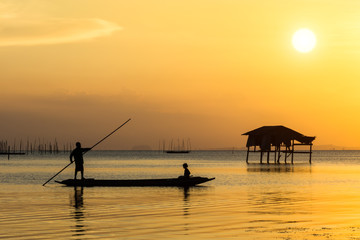 Fishermen and fishing boats float in the lake.