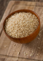 Brown rice in a bowl on wooden ыгкафсу