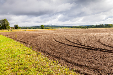 Arable land by the lake, Finland, tonning.Autumn view