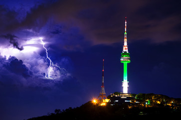 Seoul tower and Thunderstorm clouds with lightning at night. Namsan Mountain in korea