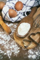 Eggs, flour, rolling pin, shape, corolla, baking ingredients with a copy of a stretch in a vintage style