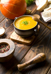 Pumpkin soup on wood
