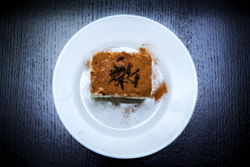 piece of cake on a plate on a dark background