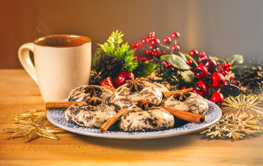 Mug with hot drink and Christmas cookies. Background with cup of chocolate, tea or coffee, festive decoration. Winter holiday concept. Beautiful cookies and bakery with cup of steaming beverage.