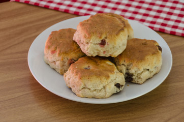 A plate of traditional English fruit and cherry scones scones