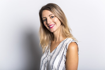 Young Woman Leaning Against Gray Wall Background