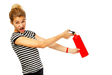 Young funny beautiful woman holding fire extinguisher over white background