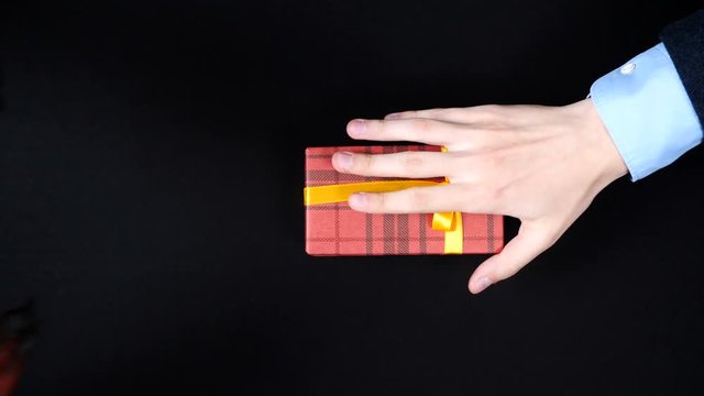 Red demon hands gives a gift to the businessman.