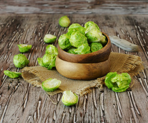 Green raw Brussels sprouts in wooden bowl , selective focus