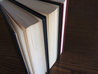 Second hand books standing on a wooden table . View from above . Top view