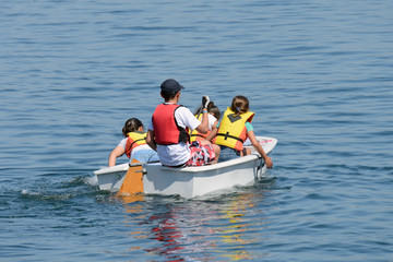 children ride on a boat in the sea