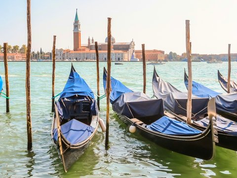 Gondolas moored in the Venetian lagoon. Venice, Italy
