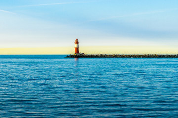 red lighthouse of Warnemuende on the Baltic Sea at the harbor , 
