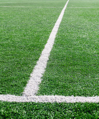 White stripe on the green soccer field from top view