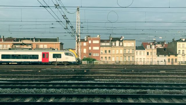 Train passes by slowly from left to right. Camera moving on same direction as passes train. 