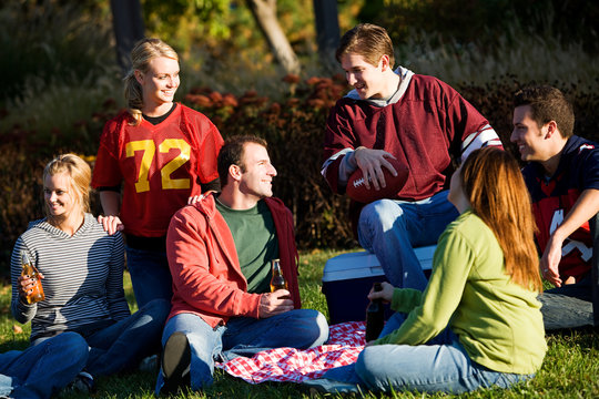 Football: Group of Friends Having Picnic in Park