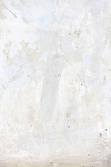 White concrete wall. Small cracks on the surface