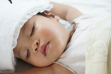 Fototapeta na wymiar Toddler asian girl sleeping 1.8 years old portrait, child sleep tight day time, recuperation because of sickness