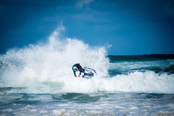 jetski turning sharply and spraying water in big waves