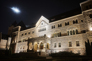 Fototapeta na wymiar emperors castle and moon in night in Poznan, Poland .
