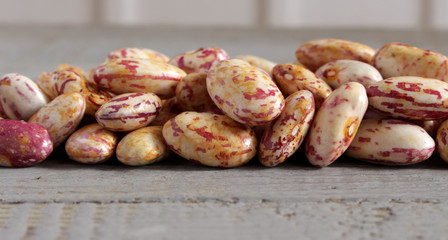 a handful of seeds beans on wooden background