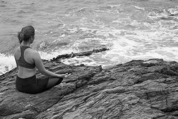 Asian woman yoga and meditation on the sea beach.